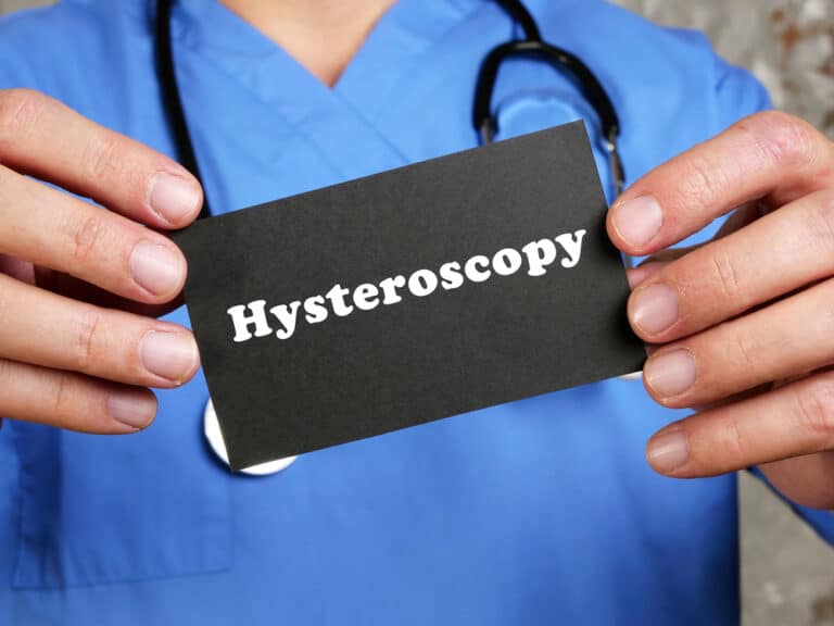 A doctor holding a Hysterectomy card